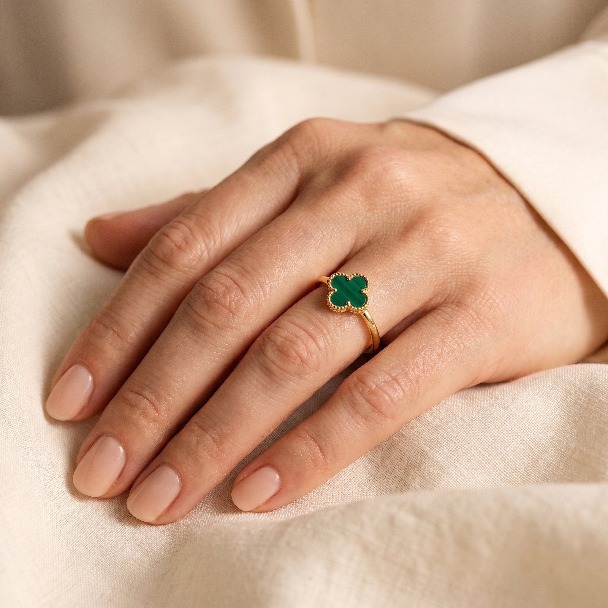 LOIRE Clover Ring worn on an elegant hand - macro