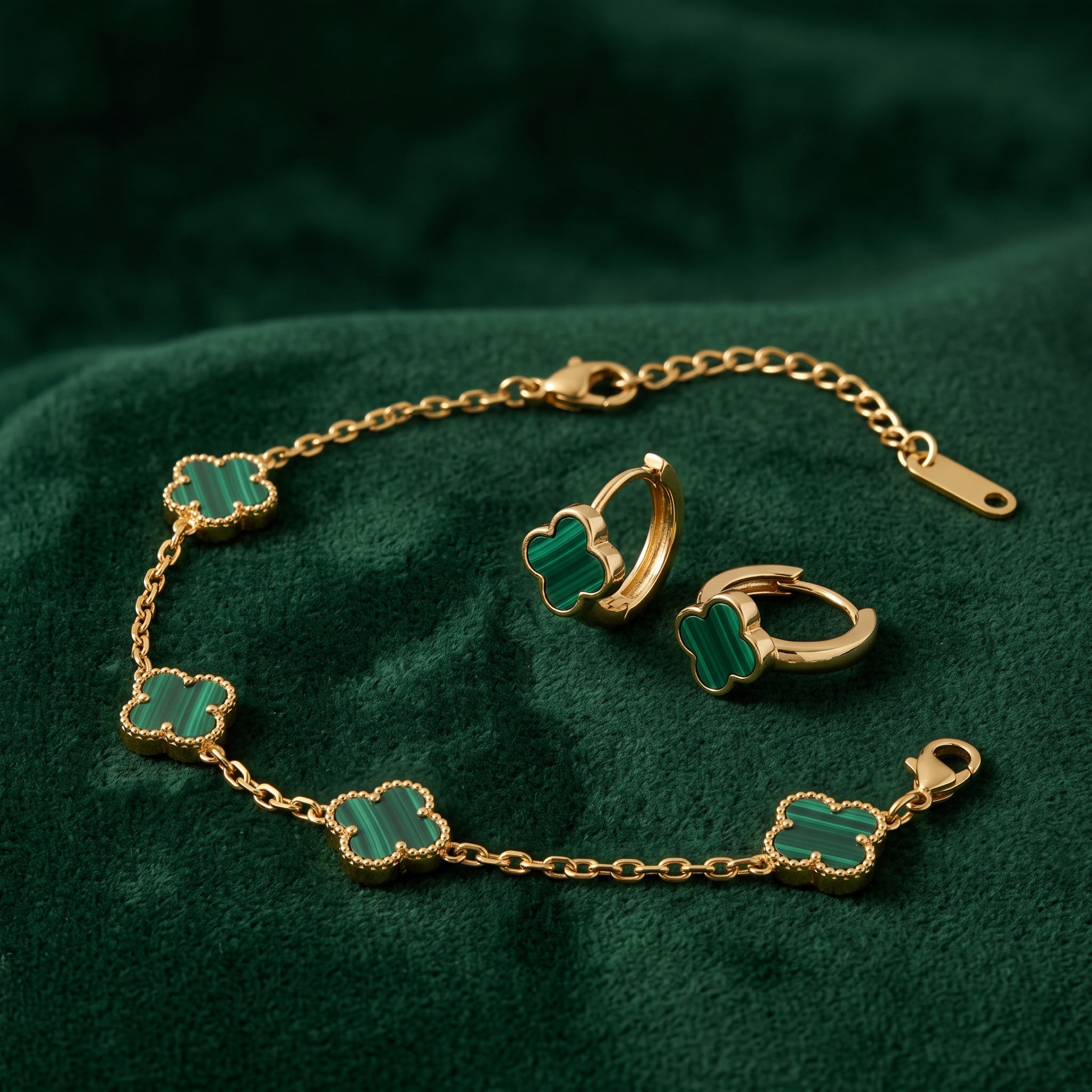 The Malachite Edit — green clover bracelet and huggies on forest green velvet
